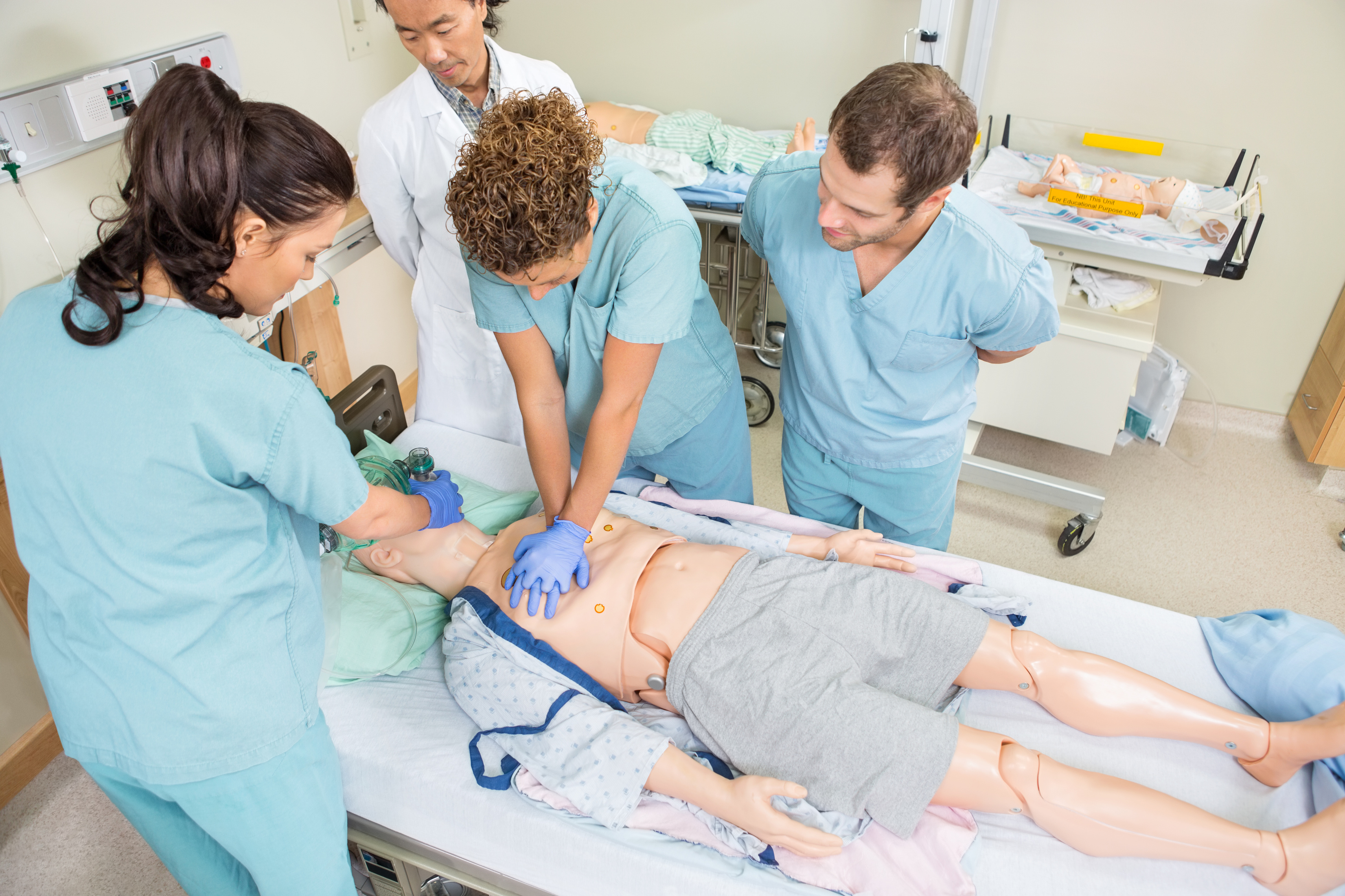 Nurses Performing CPR On Dummy Patient